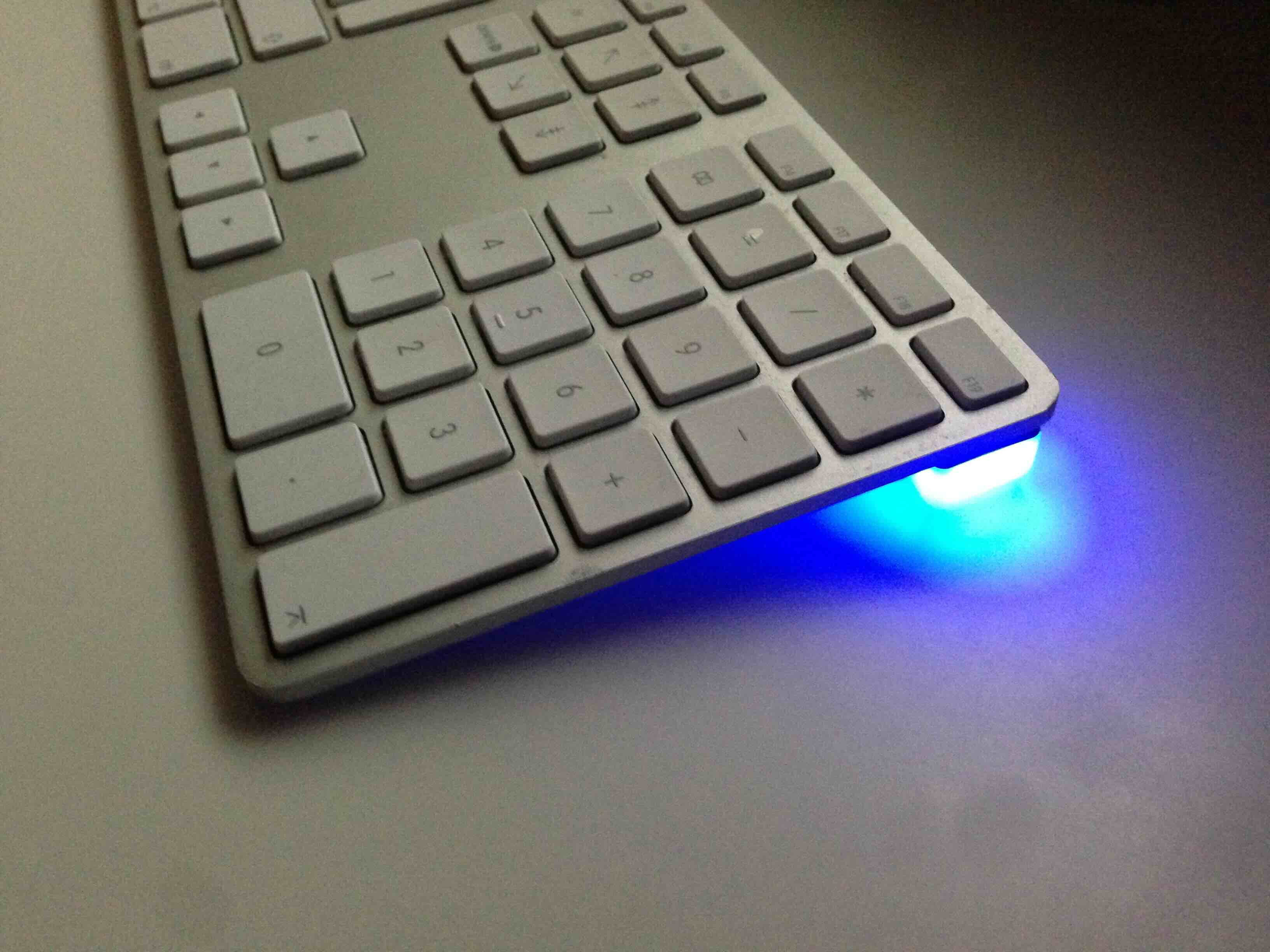 Blink(1) glowing blue tucked under Apple keyboard: I’m home!